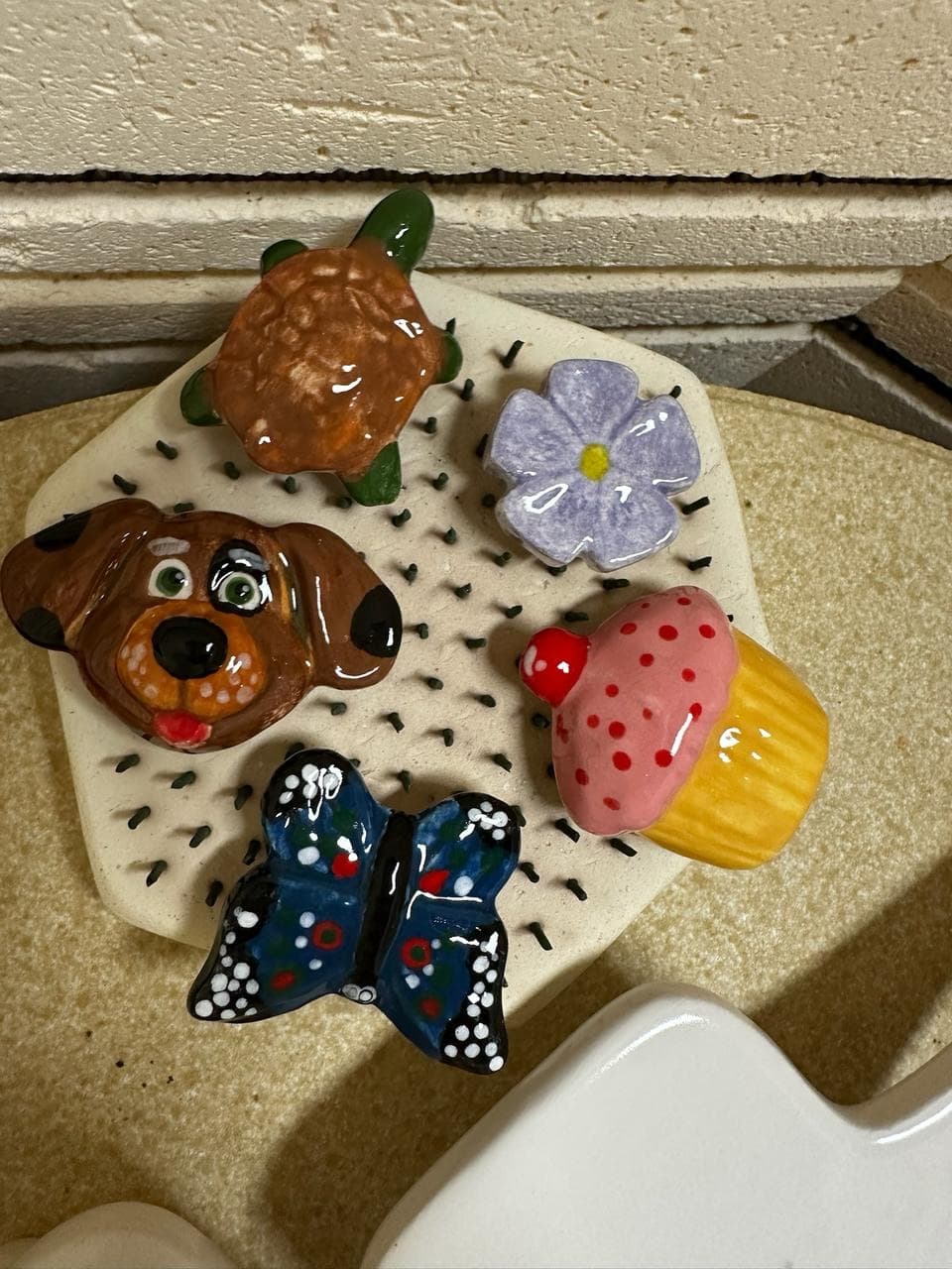 Colorful pottery figurines — turtle, butterfly, cupcake, puppy — on display at MADE @ The Local studio in Centerville, TN