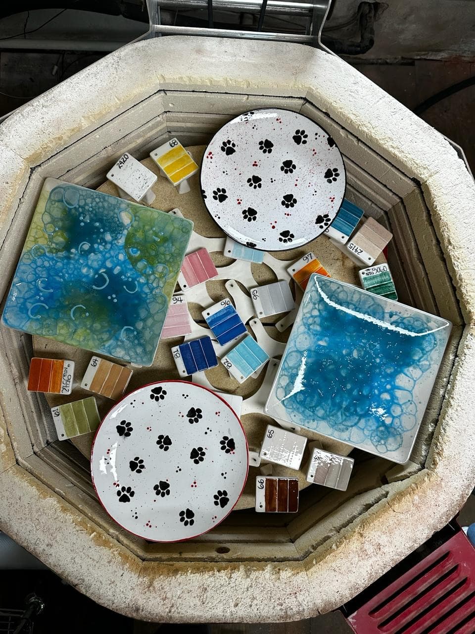 Paw print plates fresh from the kiln — so good 🐾
