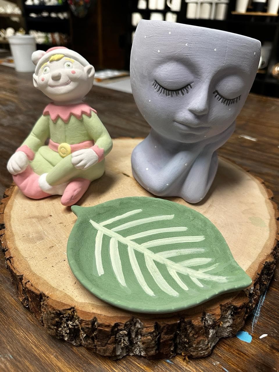 Elf figurine, face planter, and leaf dish before kiln firing at MADE @ The Local pottery studio in Centerville, TN