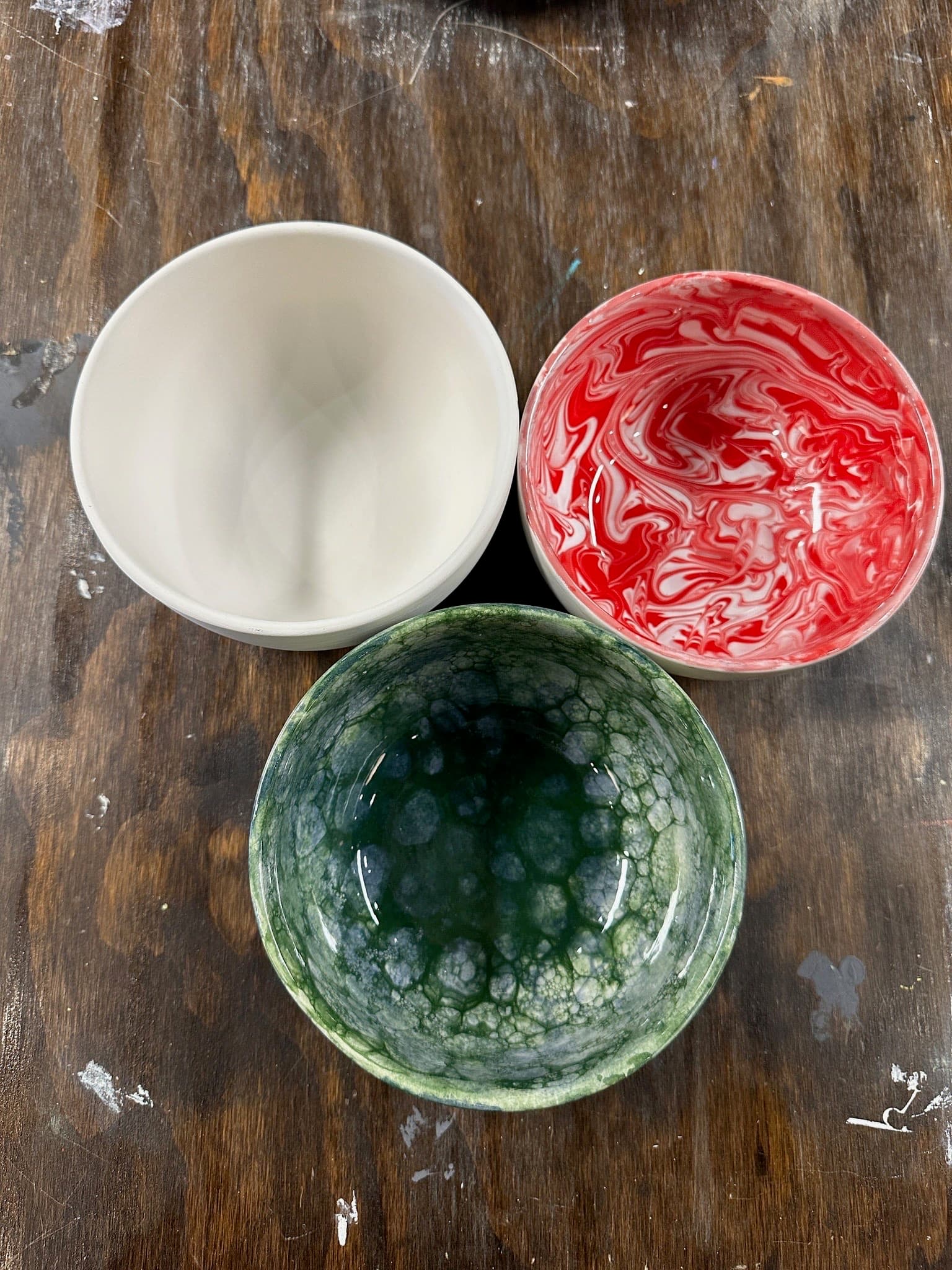 Three green painted bowls